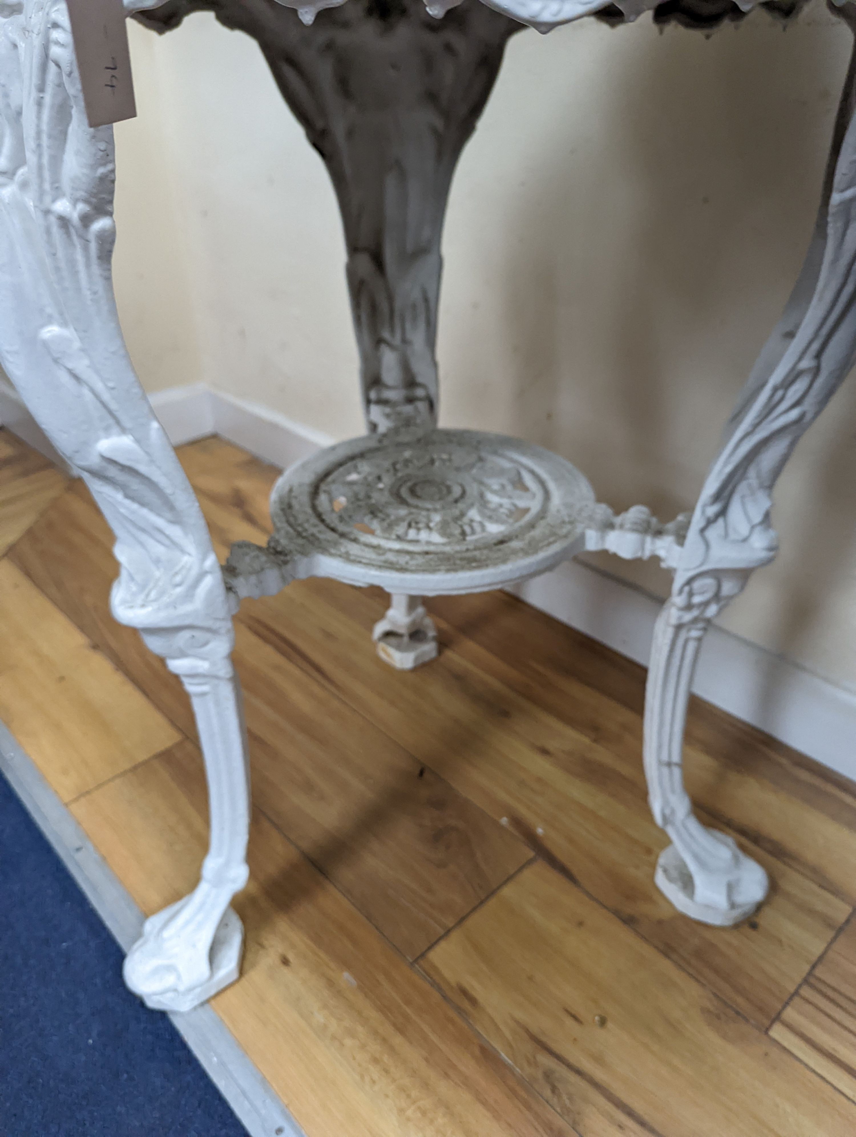 A Victorian white painted cast iron Britannia pub table, diameter 62cm, height 77cm